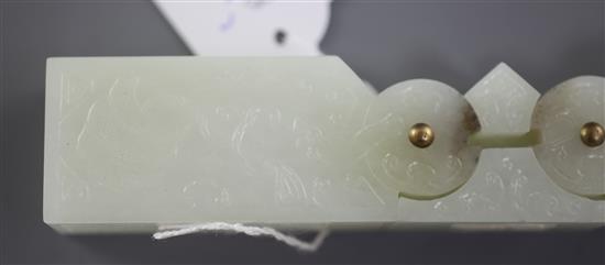 A Chinese archaistic pale celadon jade vessel or instrument, 9.5cm